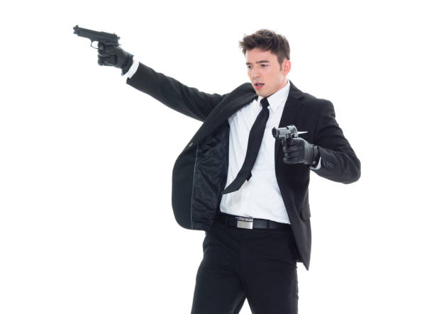 istock Handsome businessman holding a handgun 1086389670