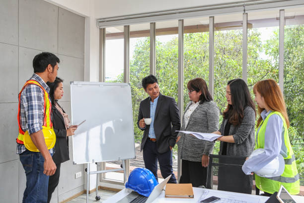 istock Engineers are meeting on the whiteboard. Blueprint Interior Design structure and development. contractor presentation for team and client in the office. Asian people. 1086389732