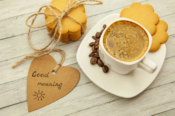 istock White cup with coffee, coffee beans and ginger biscuits, tasty breakfast concept, close-up 1086395276