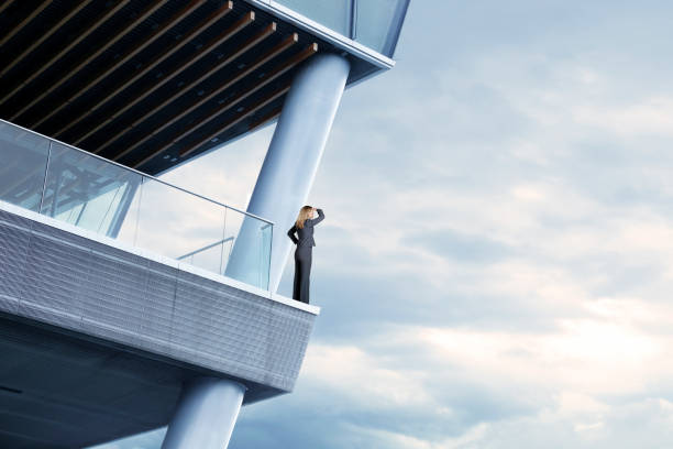 istock Businesswoman Goes Out On Ledge To Get A Better View 1086395434