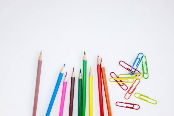 istock Office supplies concepts, Colored crayon pencils and clips on white background. 1086397272