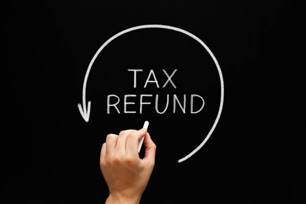 tax refund arrow concept on blackboard - refundable imagens e fotografias de stock