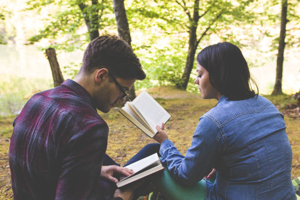 istock Couple Reading a Book On a Picnic 1086400712