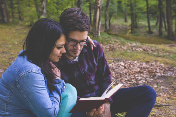 istock Couple Reading a Book On a Picnic 1086400742