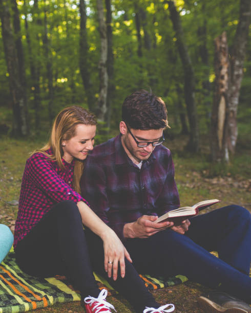 istock Couple Reading a Book On a Picnic 1086400932