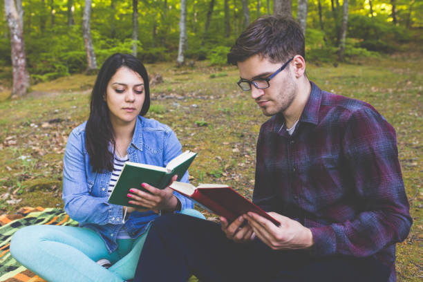 istock Couple Reading a Book On a Picnic 1086400964