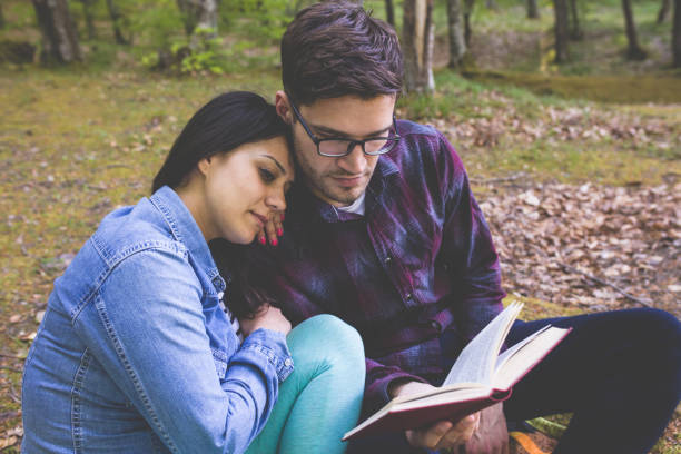 istock Couple Reading a Book On a Picnic 1086400988