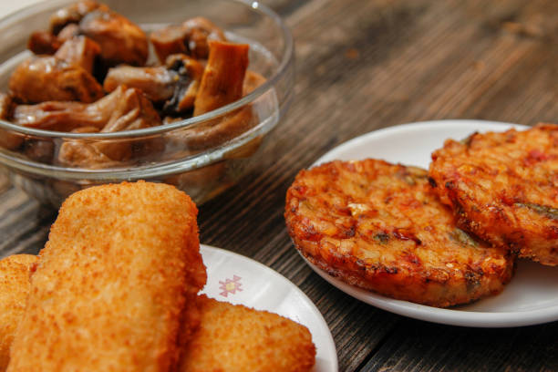 istock Fried fish filet, veggie burger and grilled champignons 1086404926