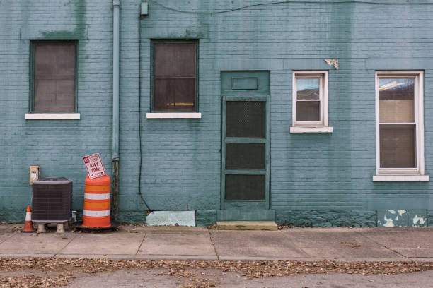 istock Orange traffic barrier in front of green building 1086407672