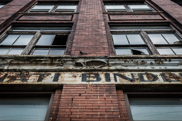 istock Looking up at vintage brick building with busted windows 1086409272