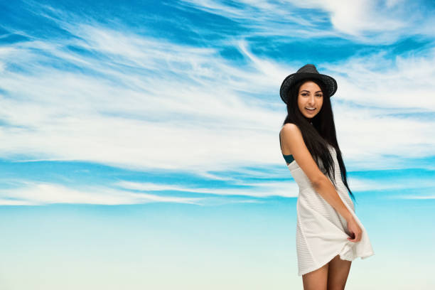 portrait of a brunette girl in nature against the sky