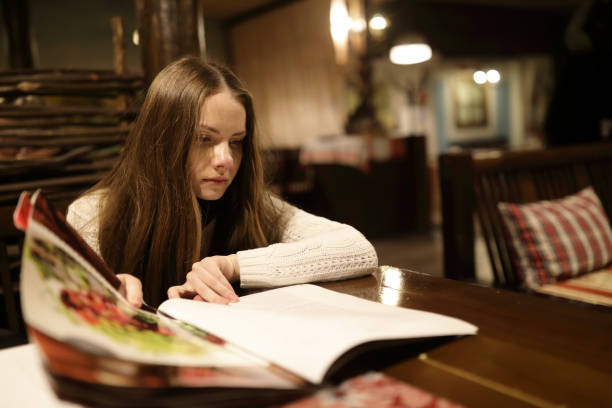 istock Woman looking at menu book 1086419460