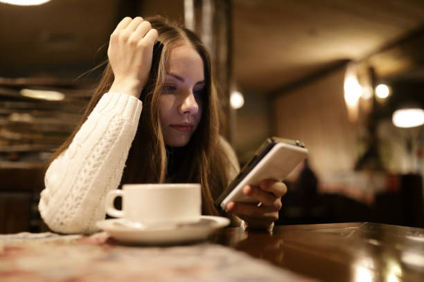 istock Woman with tea and smartphone 1086419464