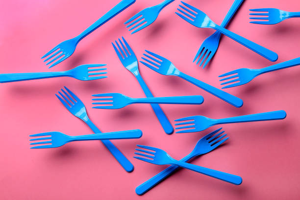 istock Close-up of blue forks on pink background. 1086427510