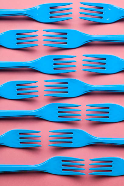 istock Close-up of blue forks on pink background. 1086427588