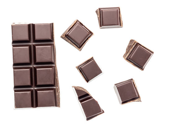 istock Chopped chocolate cubes, bitter, dark chocolate bar isolated on white background, top view 1086435558