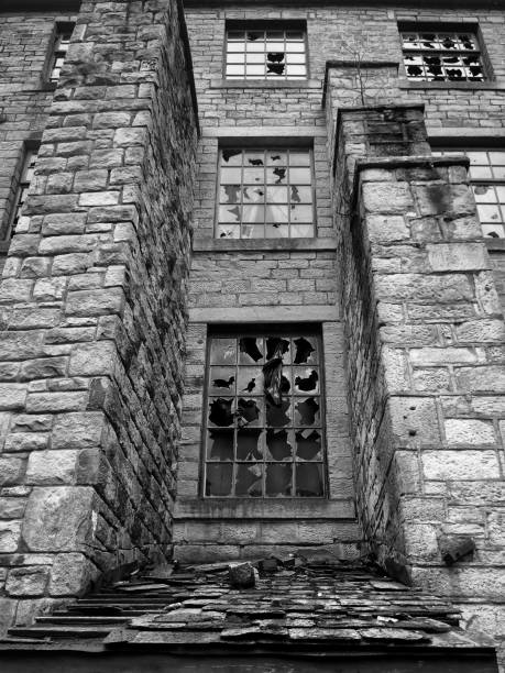 istock monochrome image of broken windows in an empty abandoned vandalized old stone building 1086442752