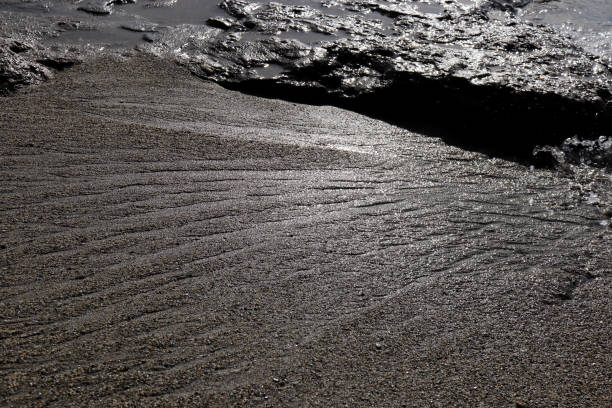 istock Sand and cliff water stock texture. Summer beach background. 1086470308