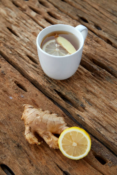istock Cup of ginger tea with lemon on wooden table 1086486444