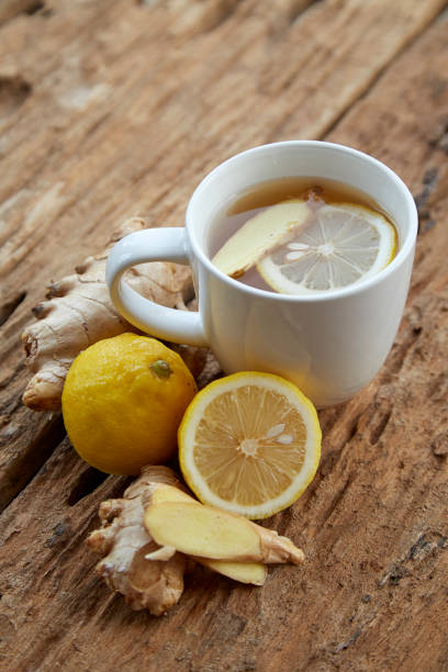 istock Cup of ginger tea with lemon on wooden table 1086486634