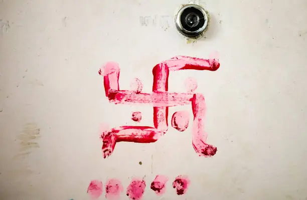 red swastik on the door for the good fortune which is Indian tradition known as Vastu Shastra.