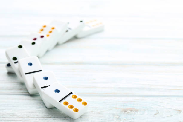 istock Dominoes on white wooden table 1086519988