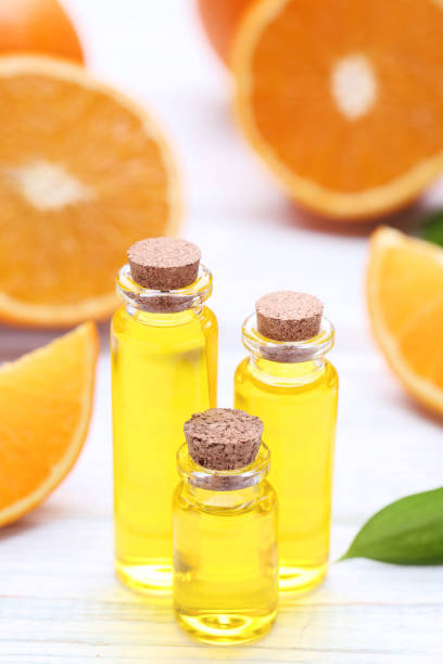 istock Orange oil in bottles on wooden table 1086521620