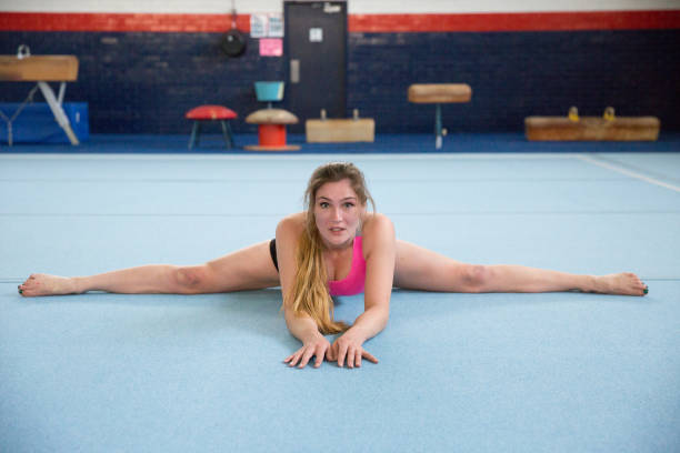 istock Gymnast Stretching on the Floor 1086523214