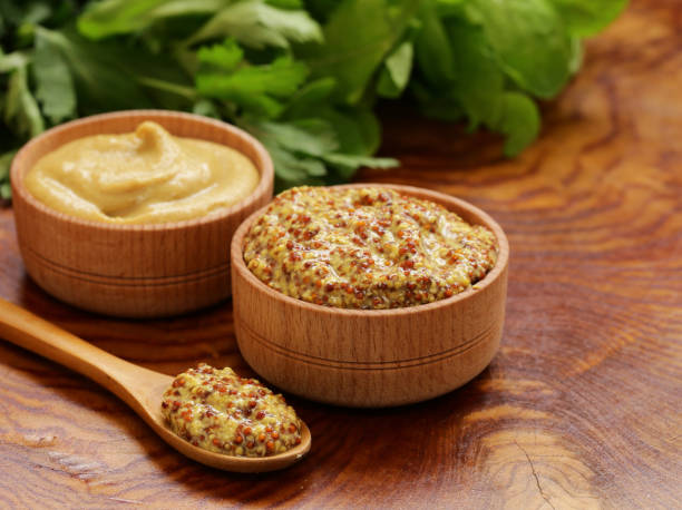 Natural mustard Natural mustard, seasoning and sauce on a wooden table dijon stock pictures, royalty-free photos & images