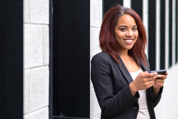 istock Smiling young woman sending a text message 1086523458