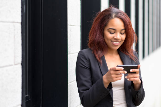 istock Smiling young woman sending a text message 1086524528