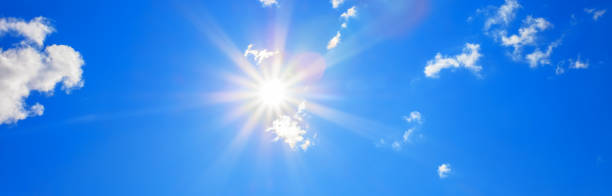 istock Sun with beautiful beams in the blue sky with some clouds 1086526828