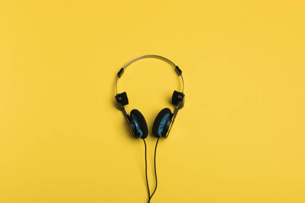 istock headphones on a yellow background 1086532578