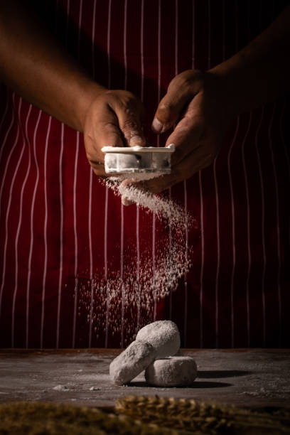 istock Chef spreading flour on bakery prepare for baking. Cook showing scatting white powder over raw homemade bakery 1086532814