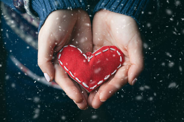 Female hands giving red heart. Close up.