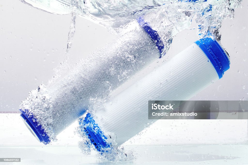 New carbon filter cartridge for house water filtration system isolated on white background. Splash. Concept. Filtration Stock Photo