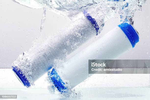 New Carbon Filter Cartridge For House Water Filtration System Isolated On White Background Splash Concept Stock Photo - Download Image Now