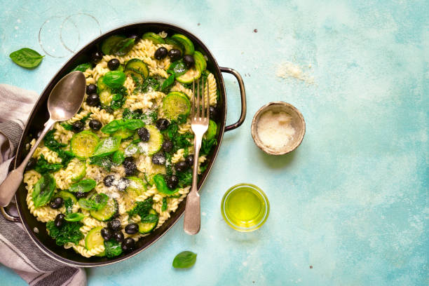 istock Summer pasta with green vegetables and black olives 1086562712