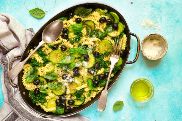 istock Summer pasta with green vegetables and black olives 1086562718