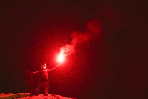 istock Snowboarder stands signal fire night 1086563840