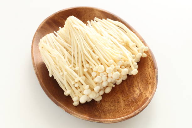 istock Japanese mushroom, Enoki on wooden plate 1086564110