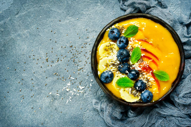 istock Mango smoothie bowl with fresh ripe berries and fruits 1086564354