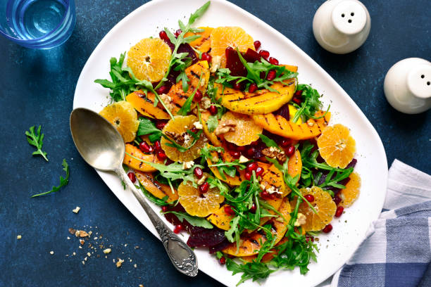 istock Pumpkin salad with arugula, beetroot, orange and nut 1086565918