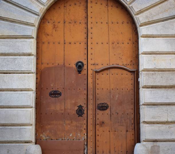 istock Wooden door, studded with iron spikes. 1086565974