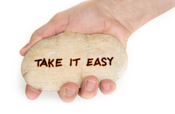 istock Pebble stone in hands. Concept for  take it easy sign 1086566432