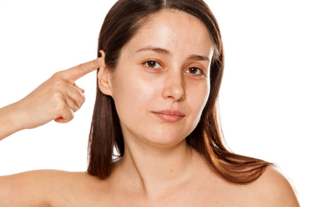 istock Beautiful young woman touching her ear on white background 1086566894