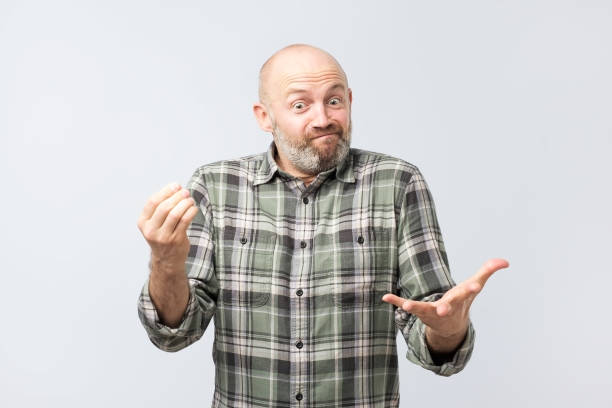 istock Mature european man explaining something simple being questioned someone, frowning and grimacing 1086568228