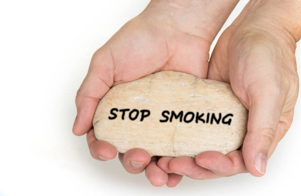 istock Pebble stone in hands. Concept for a  stop smoking sign 1086568494