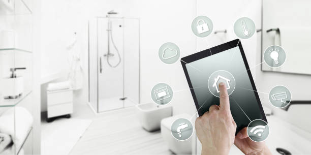 istock smart home control concept hand touch digital tablet screen with icons, isolated on blurred bathroom background, web banner and copy space template 1086574302
