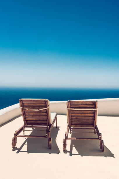 istock Sun Lounge Chair on Balcony In Santorini, Greece 1086574326